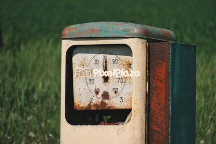 Vintage Rusty Gas Pump in a Field
